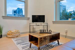 a living room with a tv and a coffee table at Bright and Modern Studio in Louisville # 302 in Louisville +56 photos