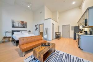 a large living room with a bed and a couch at Bright and Modern Studio in Louisville # 302 in Louisville