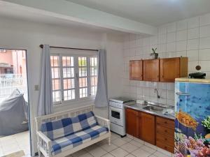a kitchen with a sink and a stove at Sieber's Residence in Florianópolis