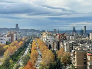 a city with buildings and trees in the foreground at Panoramic Condo in Tirana! in Tirana