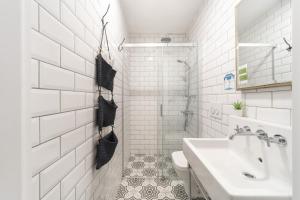 a white bathroom with a sink and a toilet at Hotel Des Arts Galata in Istanbul