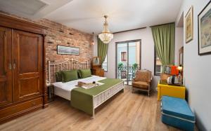 a bedroom with a bed and a brick wall at Hotel Des Arts Galata in Istanbul
