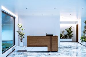 an office with a reception desk and potted plants at Neo-garden in Dali