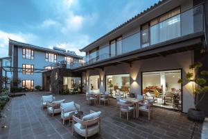 an outdoor patio with chairs and tables and a building at Neo-garden in Dali