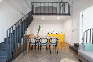 a dining room with a table and four chairs at Limehome Prague Múza in Prague +51 photos