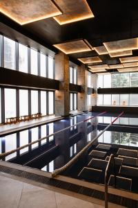 een zwembad in een gebouw met ramen bij Matei Basarab Chic Studio in Boekarest