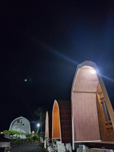 a building with a domed roof at night at Indah Damai Cottages in Sidomukti