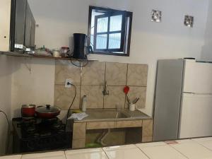 a kitchen with a sink and a stove and a refrigerator at Casa por do sol Angra in Angra dos Reis +10 photos