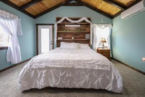 una camera con un grande letto e pareti blu di Eagle Lake Cottage a Dunnville