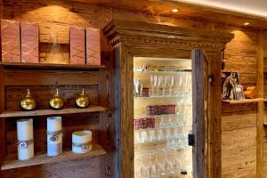 a room with wooden walls and shelves with wine glasses at Apartment Au Reduit 208 in St. Moritz
