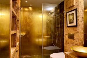 a bathroom with a glass shower and a sink at Apartment Au Reduit 208 in St. Moritz