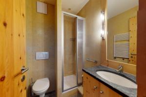 a bathroom with a sink and a toilet at Apartment Sur Puoz 1A in Samedan +3 photos