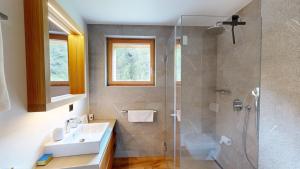 a bathroom with a sink and a shower at Apartment Margnetta in Maloja +5 photos