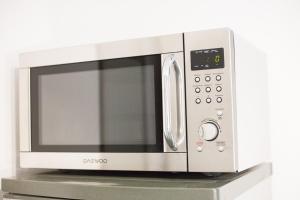 a microwave oven sitting on top of a shelf at Studio zone piétonne à Saverne in Saverne