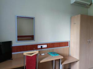 a room with a table and a mirror on the wall at Fortuna Hotel in Miskolctapolca