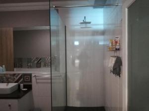 a shower with a glass door in a bathroom at Beach Club 503 Diaz Beach Mosselbay in Mossel Bay +14 photos