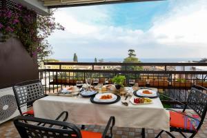 a table with plates of food on a balcony at Marriott CIAO LAGO Family Apartment DesenzanoLoft Official Partner Homes & Villas by Marriott Bonvoy in Desenzano del Garda
