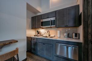 a kitchen with blue cabinets and a sink at Cove Creek Lodge 208 Accessible Double Queen Room ADA in Oakland +5 photos