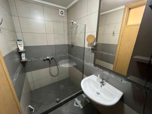 a bathroom with a sink and a shower with a mirror at Malvex in Belgrade +10 photos