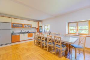a kitchen with a dining room table and chairs at Villa Hills in Janja Gora