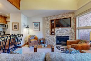 a living room with a couch and a fireplace at Lion Square Lodge South 556 in Vail