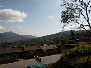 a view of a town with mountains in the background at Hotel DARPAN PALACE in Suryodaya