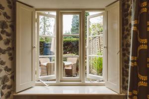 an open window with a view of a patio at The Swan Hotel in Bibury