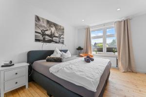 a bedroom with a bed and a large window at Huus Johann in Greetsiel
