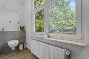 a bathroom with a toilet and a window at Huus Johann in Greetsiel +27 photos