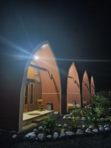 a house with surfboards painted on the side of it at Indah Damai Cottages in Sidomukti