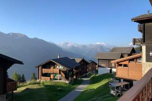 a group of buildings with mountains in the background at Chalet Wurzenbord 1 in Bettmeralp