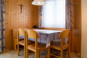 a dining room with a table and chairs and a window at Chalet Wurzenbord 1 in Bettmeralp