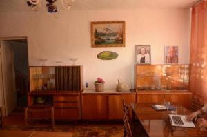 a living room with a table and a laptop on it at Гостевой дом Sabyl in Cholpon-Ata