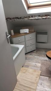 a bathroom with a bath tub and a dresser at HYPER CENTRE COSY DUPLEX dans les remparts in Boulogne-sur-Mer