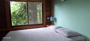 Postel nebo postele na pokoji v ubytování Cabaña Laurel