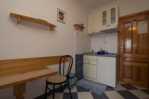 a kitchen with a counter and a table and a stool at Apartments Jadranka in Sućuraj