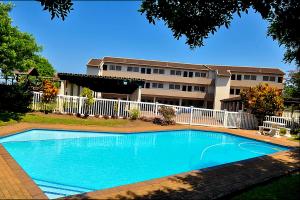 a swimming pool in front of a apartment building at Ithaca 9 Margate in Margate
