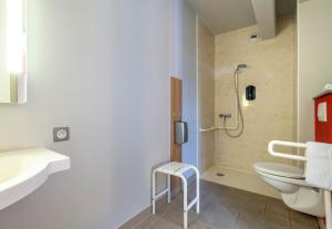 a bathroom with a toilet and a sink and a shower at B&B HOTEL La Rochelle Beaulieu Puilboreau in Puilboreau