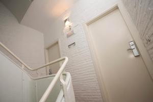 a staircase with a white door and a white brick wall at SingularStays Botanico29 in Valencia +87 photos