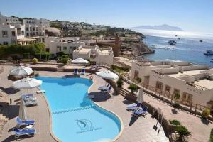 an aerial view of a resort with a swimming pool at sharks bay oasis aqua park in Sharm El Sheikh +14 photos