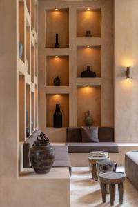 a living room with a couch and vases on the wall at TheSoulHouseBali in Canggu