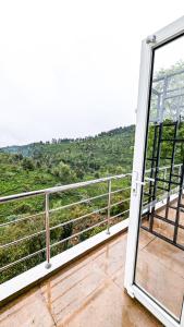 an open door to a balcony with a view at VALLEY VIEW INN, Kotagiri in Kotagiri +20 photos