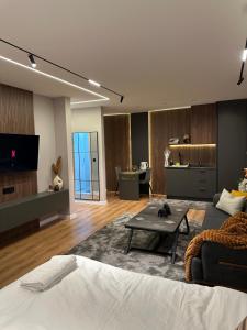 a living room with a bed and a couch and a table at Aparte - Tophane in Pristina
