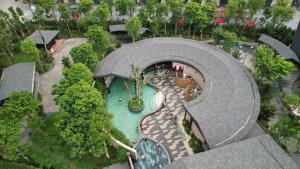 an overhead view of a building with a swimming pool at Lotus Wyndham Thanh Thủy in Phú Thọ