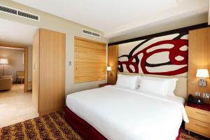 Кровать или кровати в номере Radisson Blu Hotel, Doha