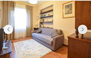a living room with a couch and a tv at Casa Martina in Camaiore