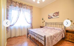a bedroom with a bed and a window at Casa Martina in Camaiore +10 photos