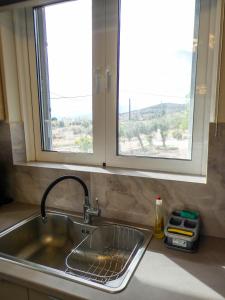 a sink in a kitchen with a window at MG Studio Kineta in Kineta +52 photos