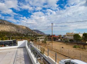 a view from the balcony of a house with mountains in the background at MG Studio Kineta in Kineta