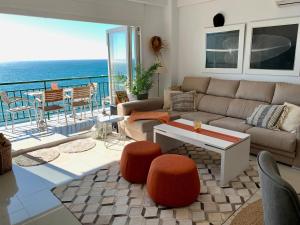 a living room with a couch and a view of the ocean at Beachfront Apartment In Fuengirola in Fuengirola +7 photos